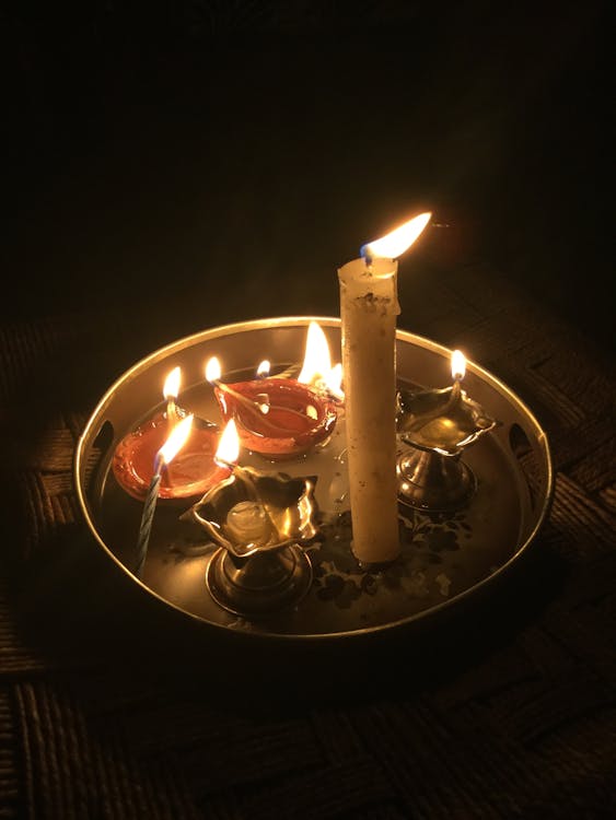 Lighted Candles on Round Golden Plate