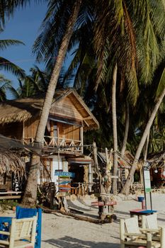 Brown Wooden Houses On Beachside Under Coconut Trees