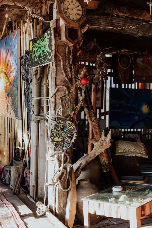 Free A creatively decorated rustic shack featuring wooden crafts and vibrant art pieces. Stock Photo