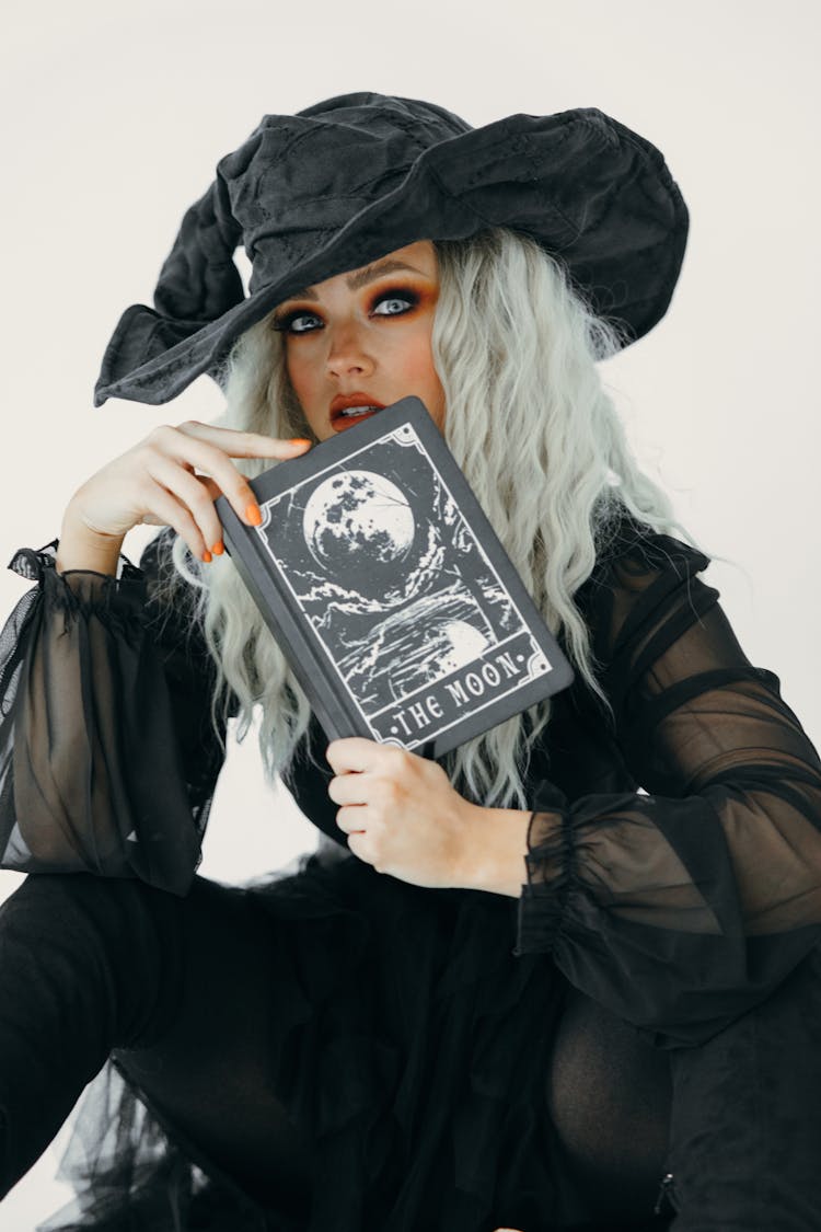 Woman In Witch Costume With A Book