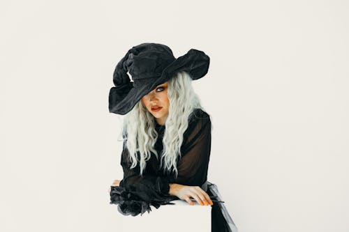 A fashionable woman in a trendy witch costume posing with elegance. Perfect for Halloween themes.