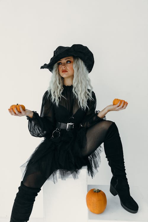 Free Woman in Witch Costume Holding Two Pumpkins Stock Photo
