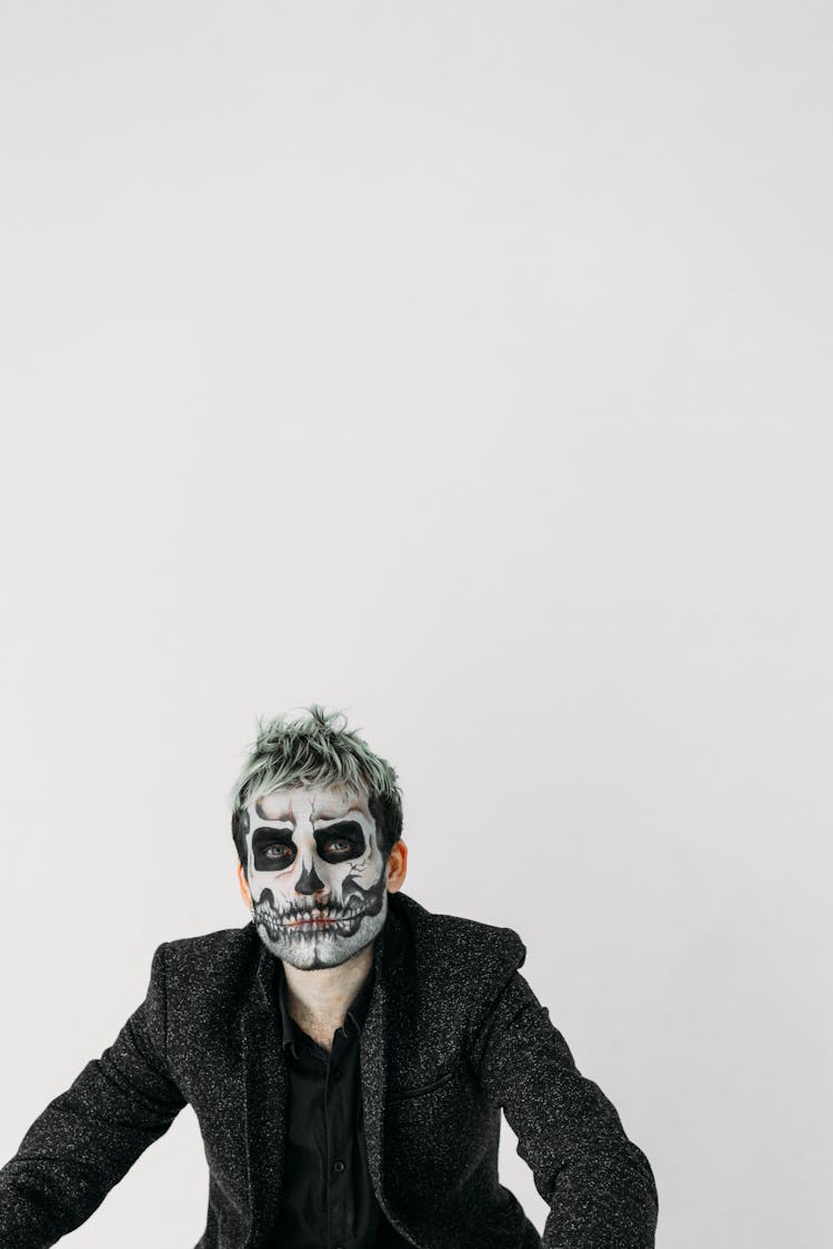 Man In Black Suit Jacket Wearing A Skull Face Paint