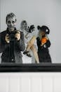 Reflections Of Three People With Different Halloween Costumes