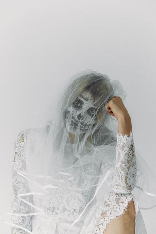 Free A haunting bridal fashion portrait with skull face paint and veil. Stock Photo