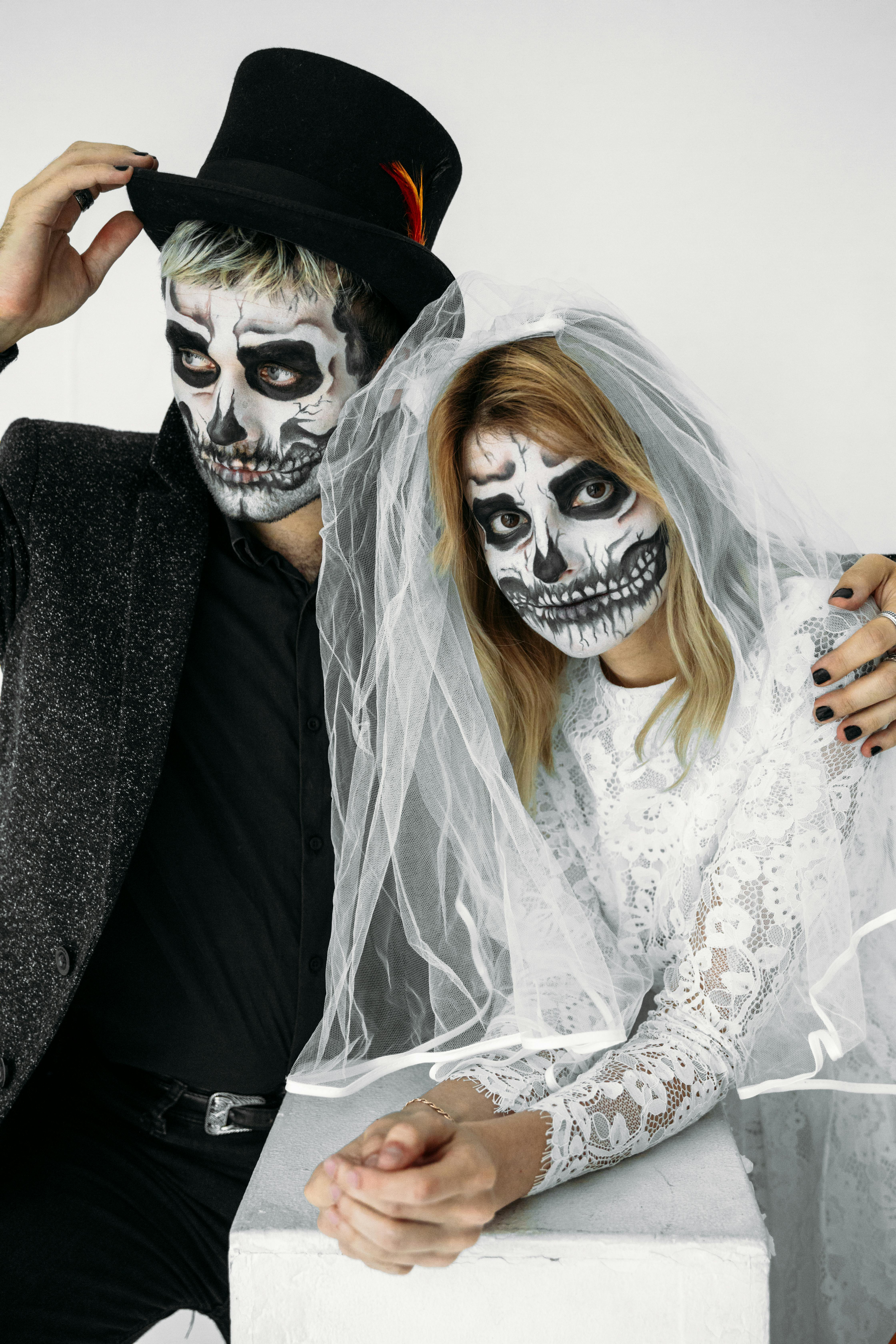 man and woman wearing skull face paint