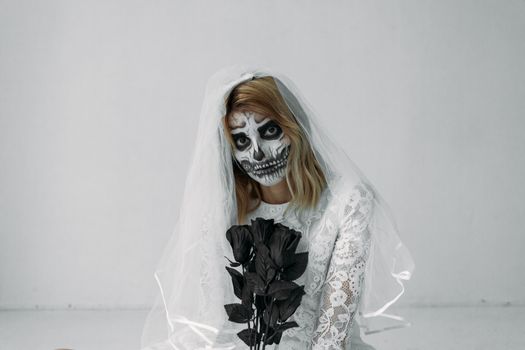 Woman in White Lace Dress Holding Black Roses