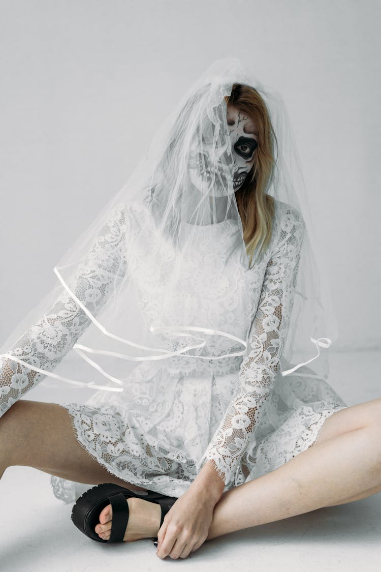 Woman In White Lace Dress And Skull Face Paint