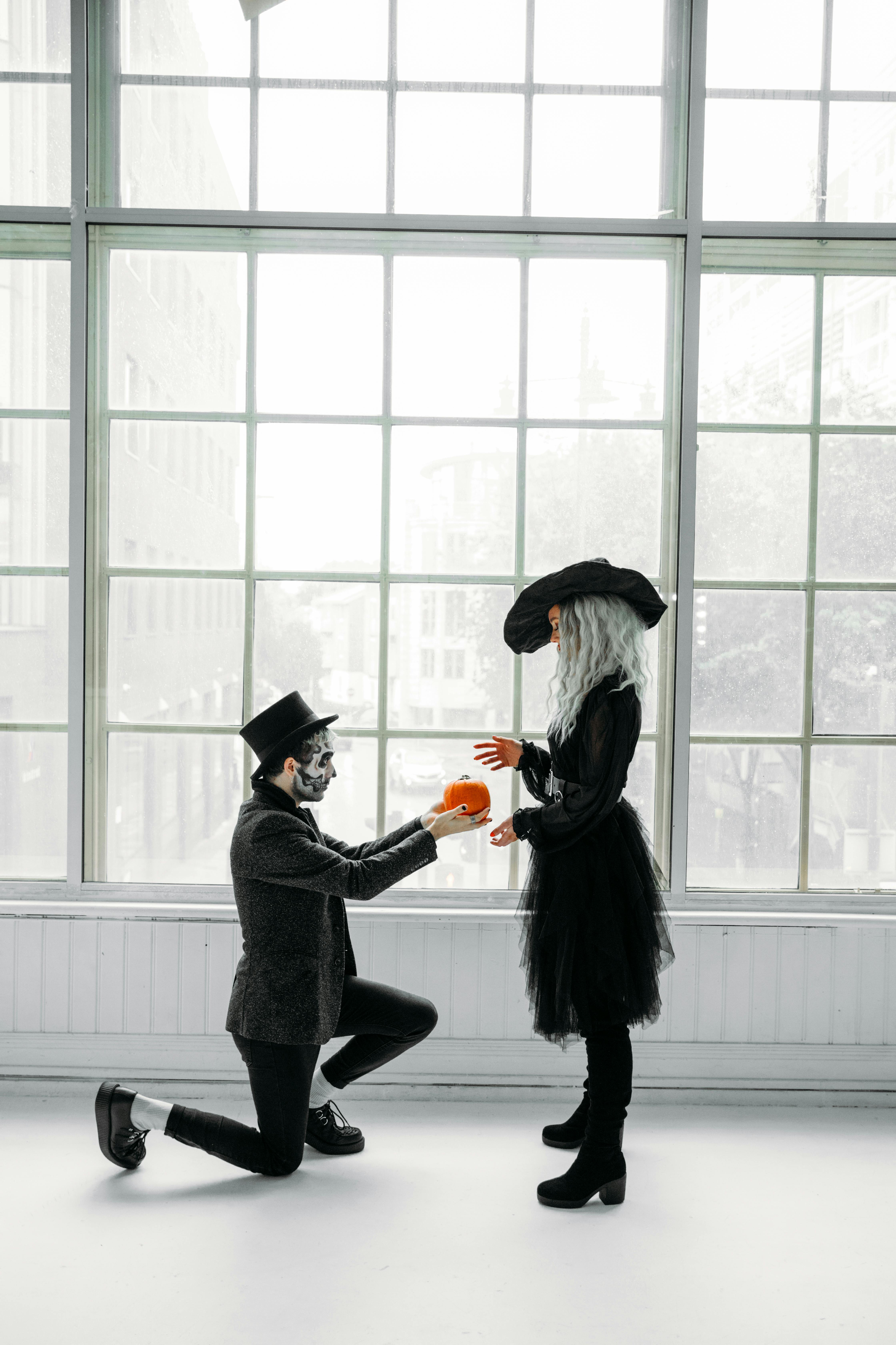 man giving a pumpkin to a woman