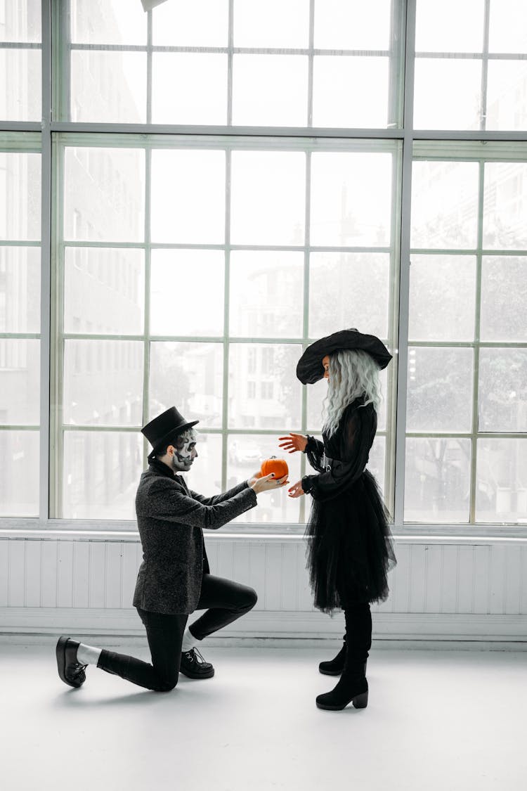 Man Giving A Pumpkin To A Woman