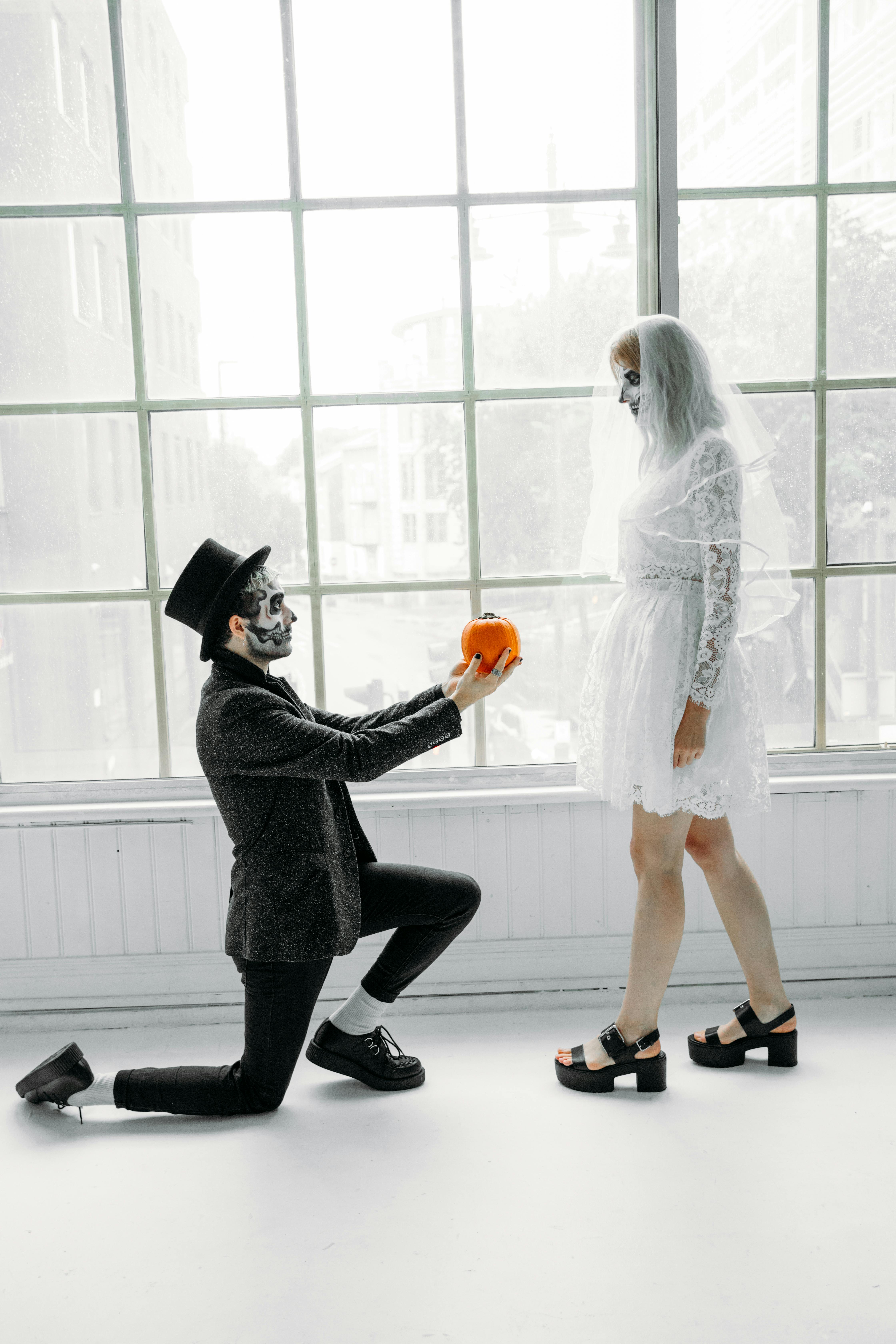 man offering a pumpkin to a woman