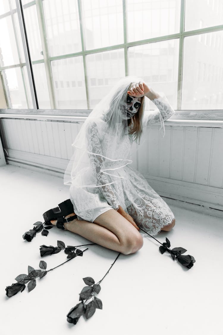 Woman In White Wedding Dress Sitting On The Floor