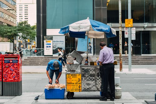 Man working behind street food cart