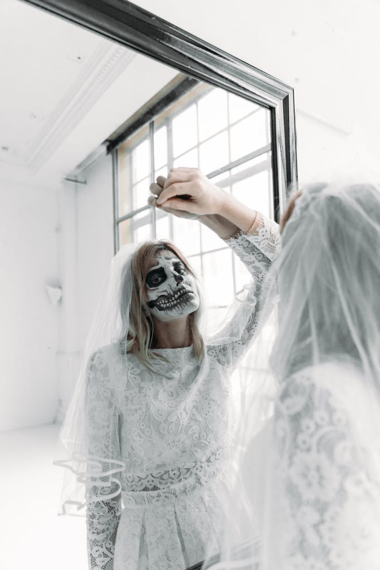 Reflection Of A Woman In A Wedding Dress With Face Paint