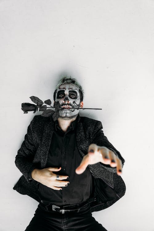 Man Lying On The Floor With A Scary Face Paint