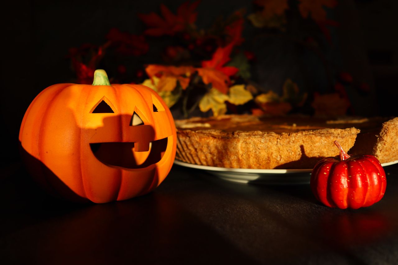 warm autumn scene featuring a jack o lantern and pumpkin pie perfect f