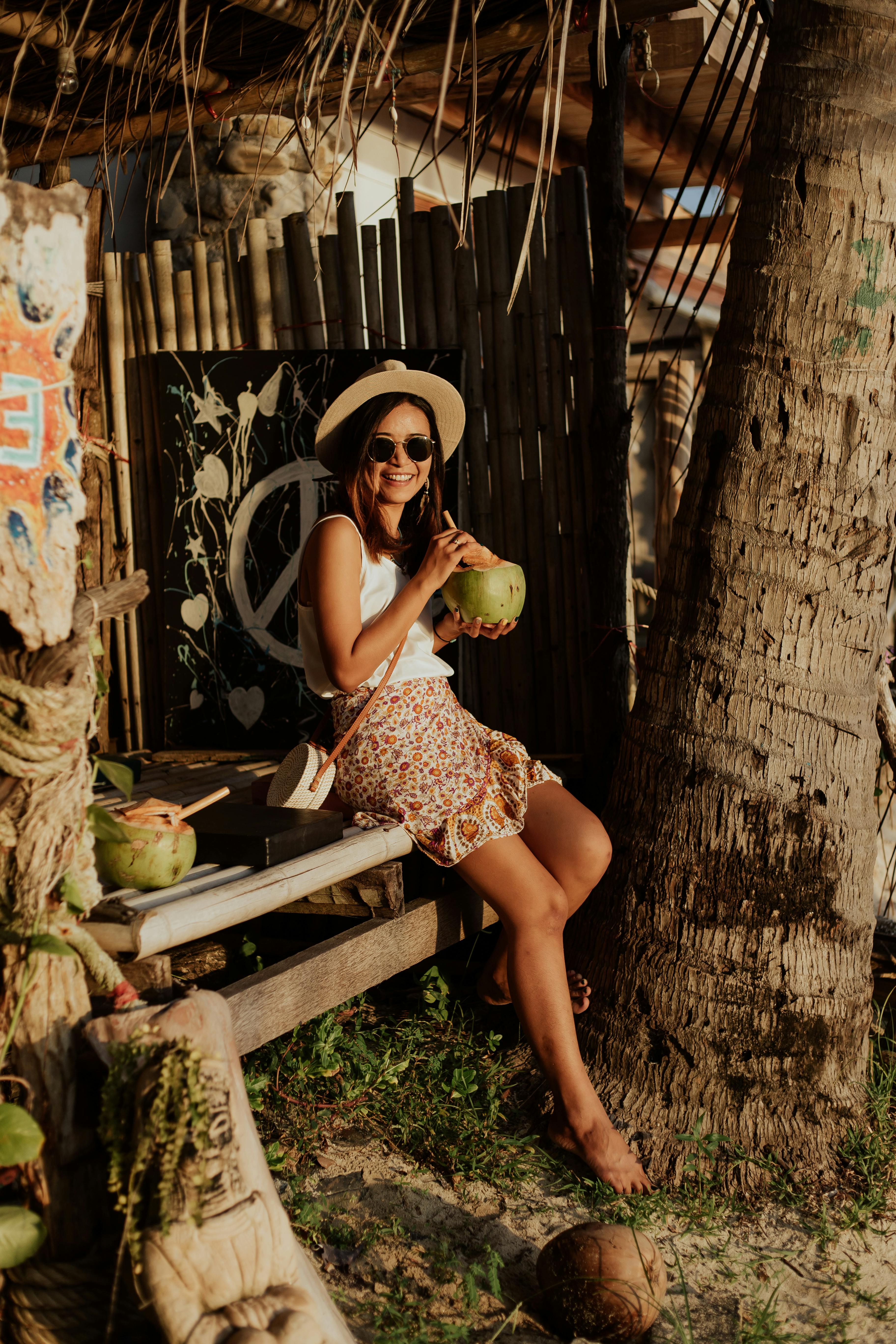 happy woman in vacation drinking a coconut juice