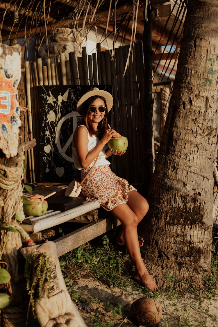 Happy Woman In Vacation Drinking A Coconut Juice 