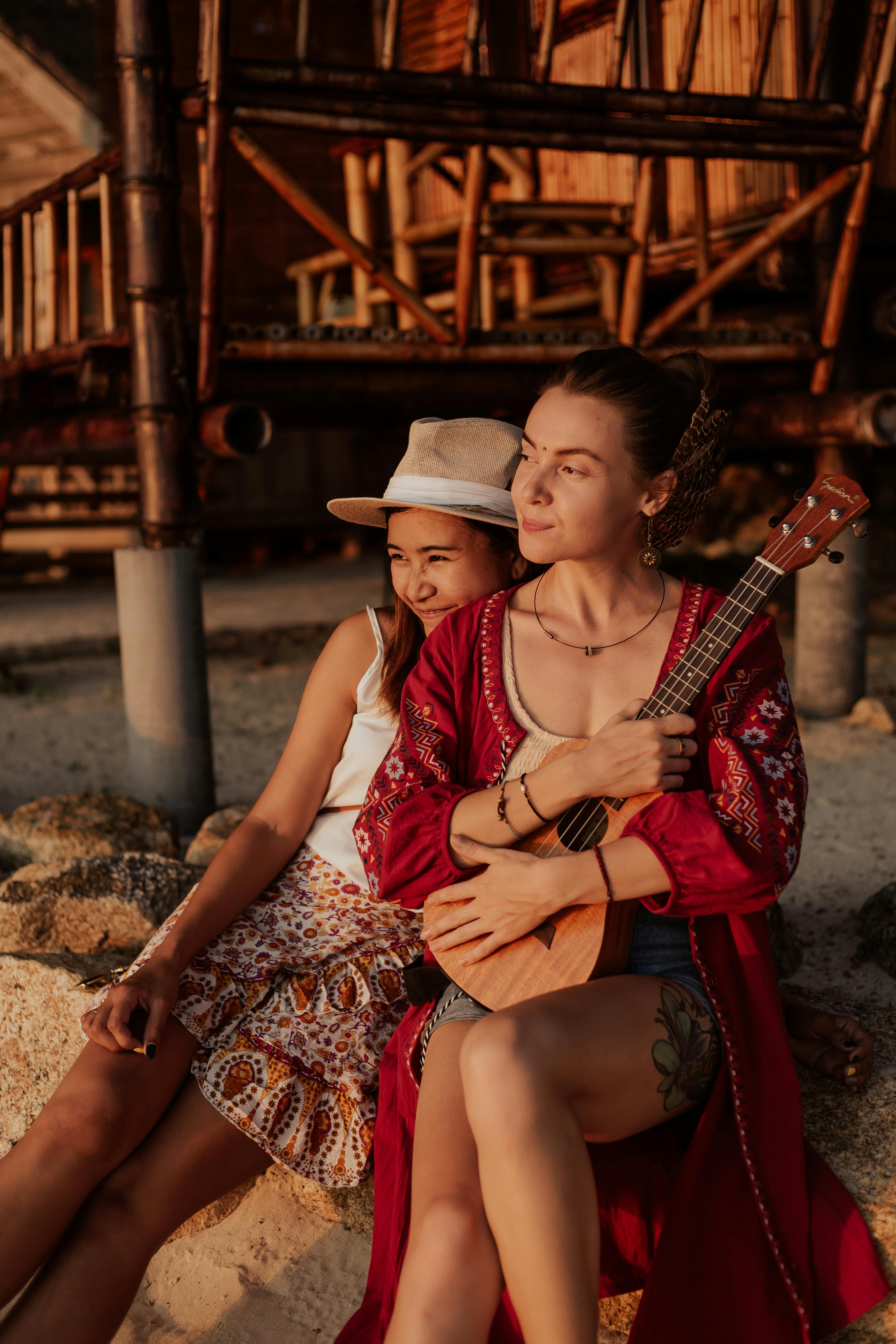 women sitting together on rock