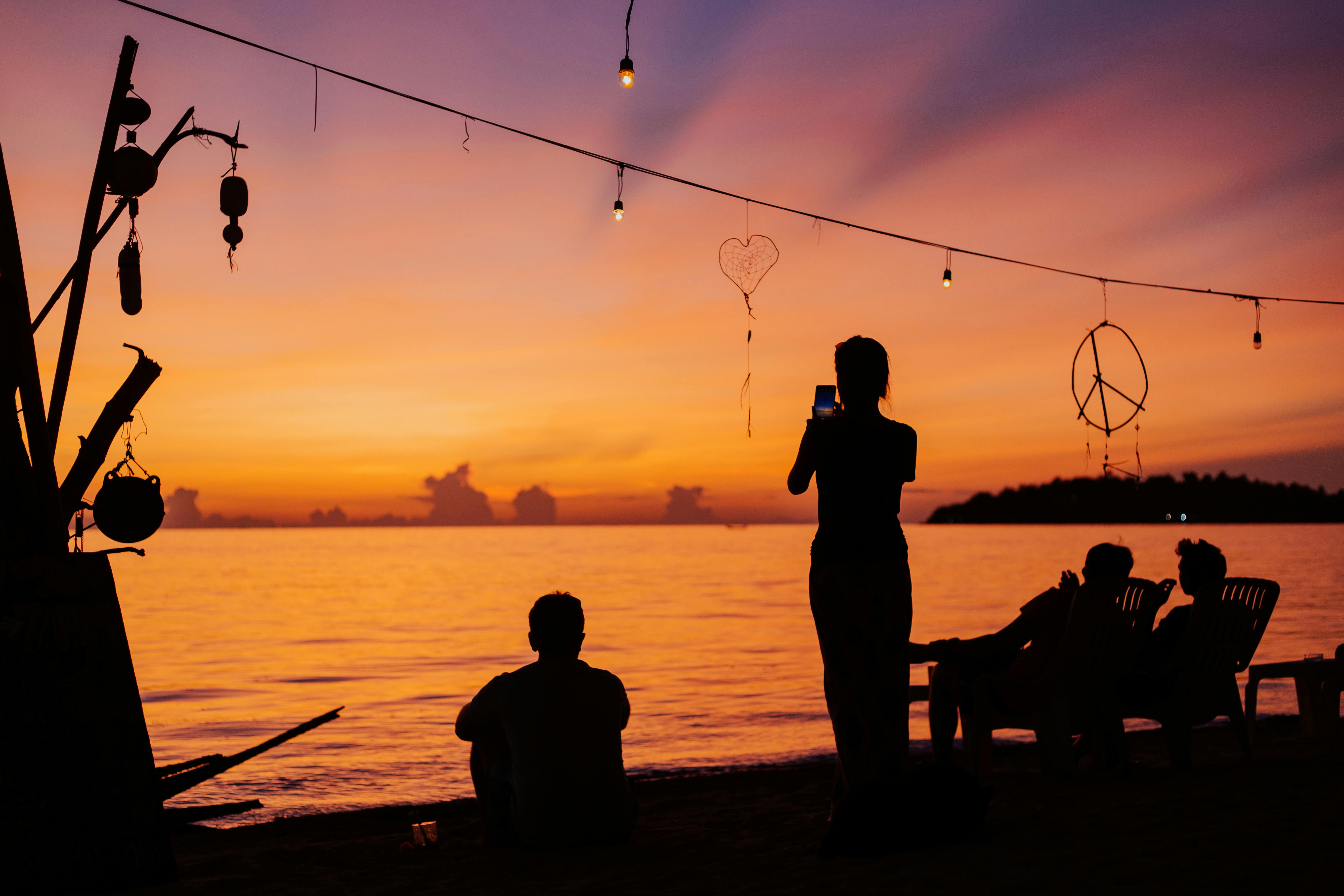 silhouette of people near beach