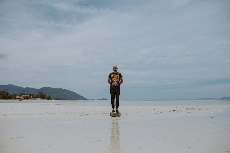 Man Standing On A Rock Wearing Face Mask