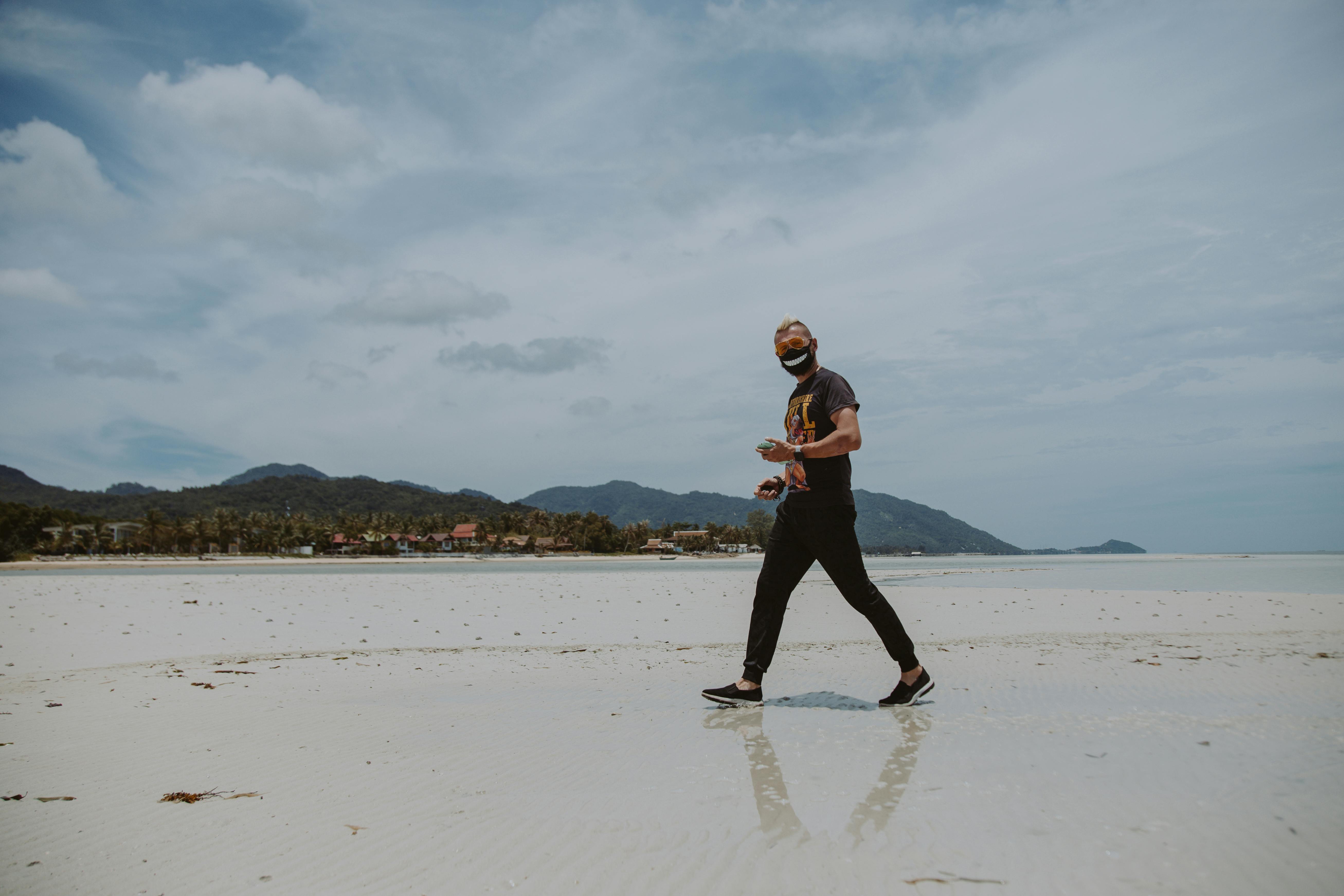 man walking on a sunny beach