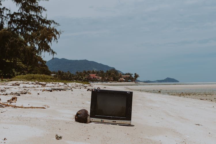 An Old Television On A Beach