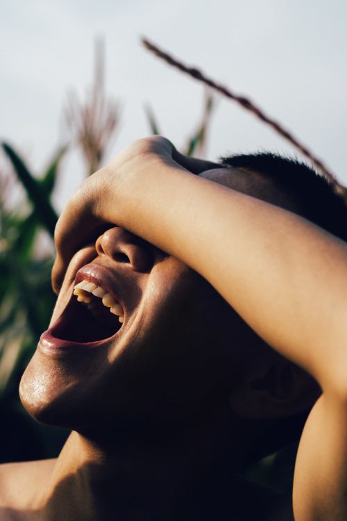 Free Close-up of a joyful person outdoors in natural light. Stock Photo