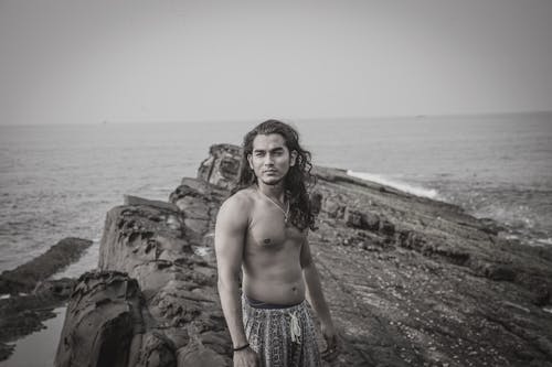Free Photo of a Man with Long Hair Standing Near the Sea Stock Photo