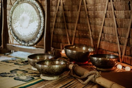 Tibetan singing bowls and gong for meditation and sound healing rituals.