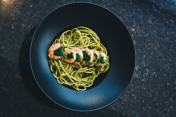 Overhead Shot Of A Pasta Dish With Green Sauce