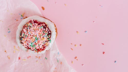 Free White and Brown Donut With Pink and Blue Sprinkles on Top Stock Photo