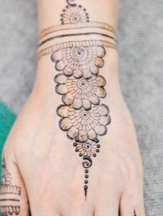 Floral henna design on the back of a hand