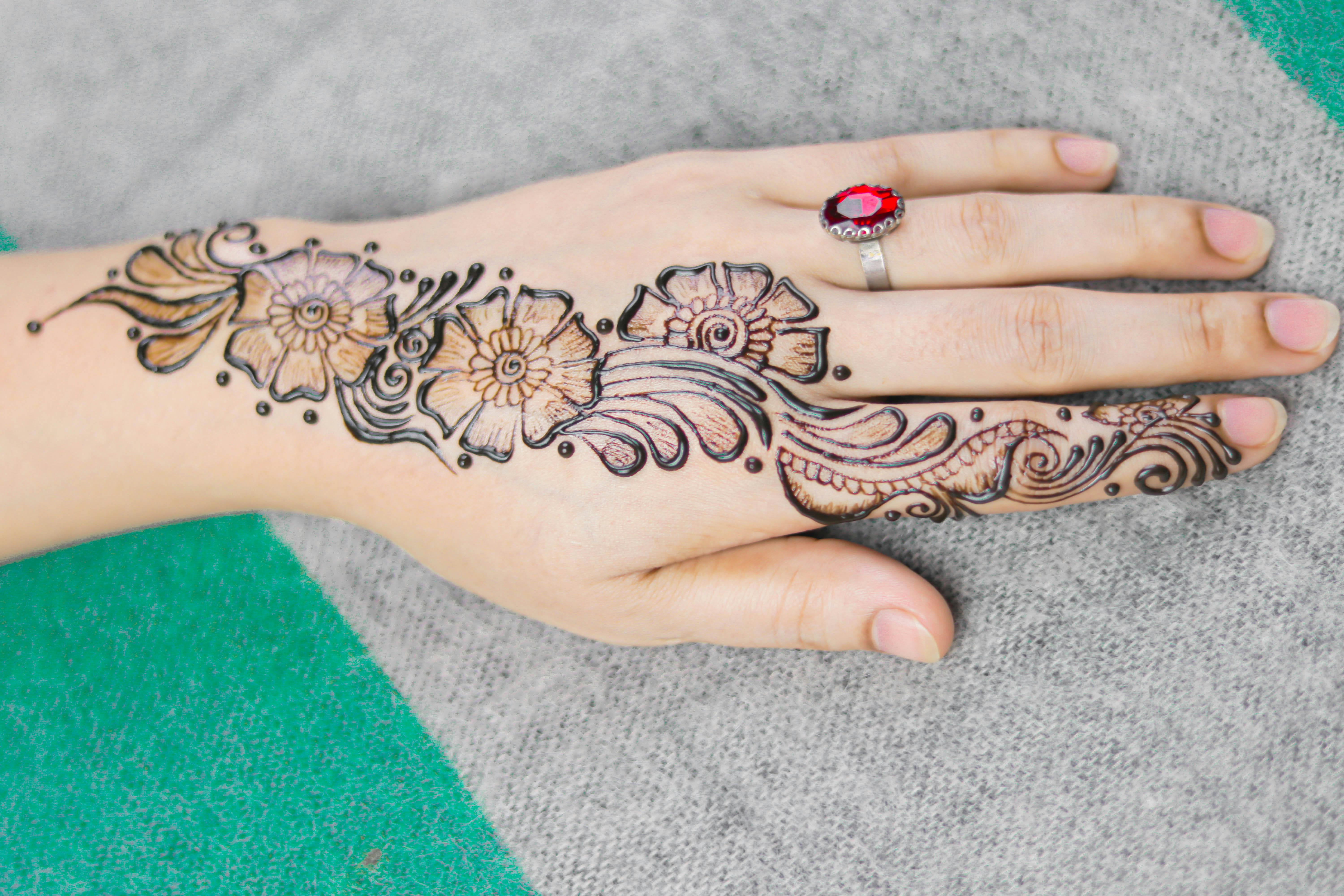 Traditional Floral Design Henna Tattoo on a Woman's Hand · Free Stock Photo