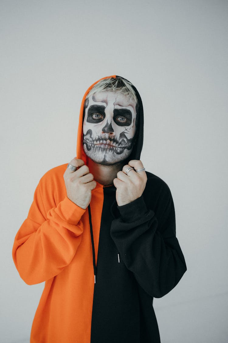 Man In Orange And Black Hoodie With Halloween Face Art