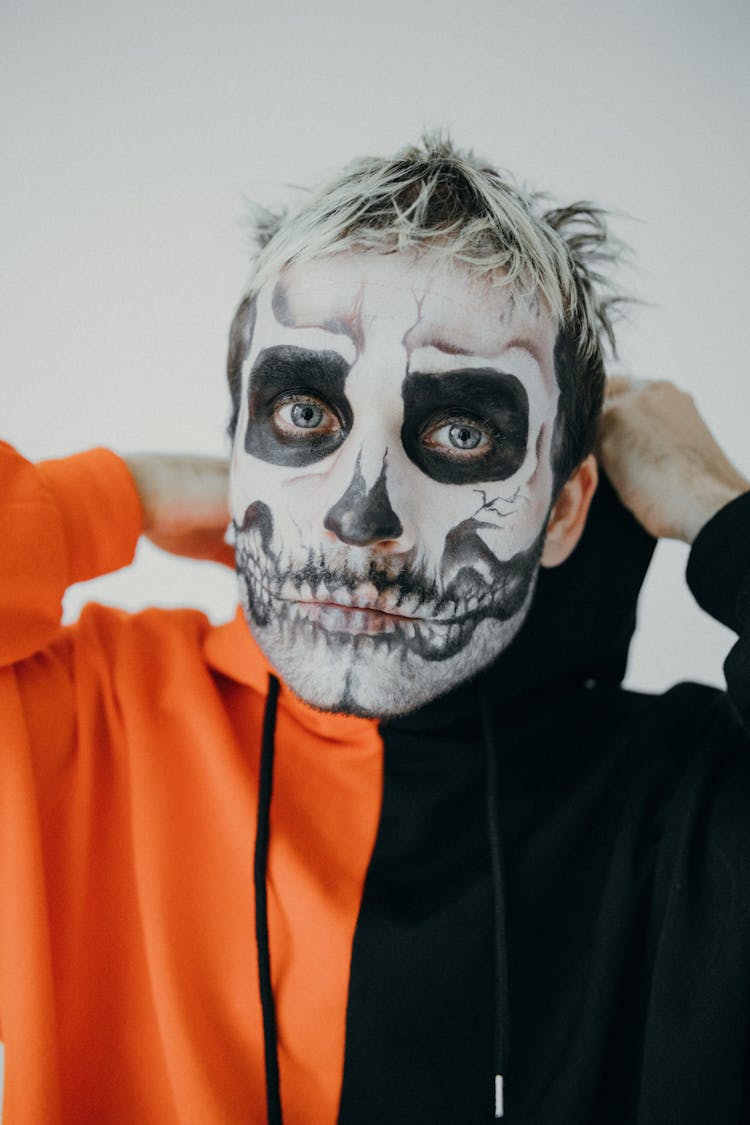 Man In Orange And Black Hoodie With Halloween Face Art