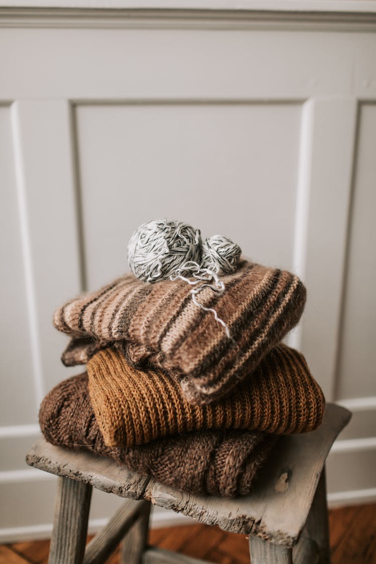 Folded Knitted Sweater On Wooden Stool