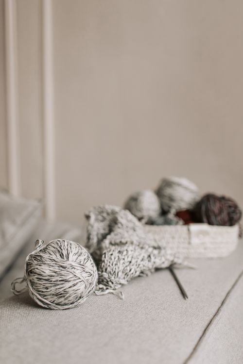 Free A tranquil indoor scene featuring yarn balls and knitting needles, perfect for craft or hobby enthusiasts. Stock Photo
