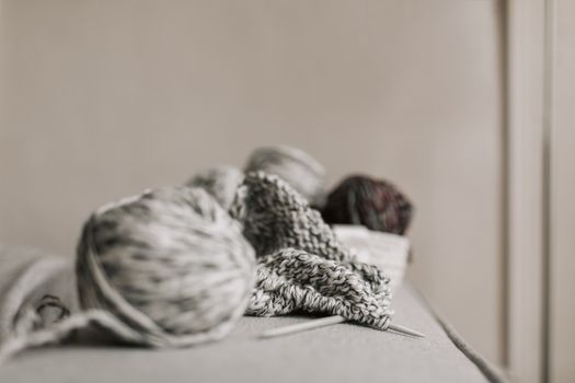A cozy scene featuring knitting needles, yarn, and a handmade project in a minimalist setting.