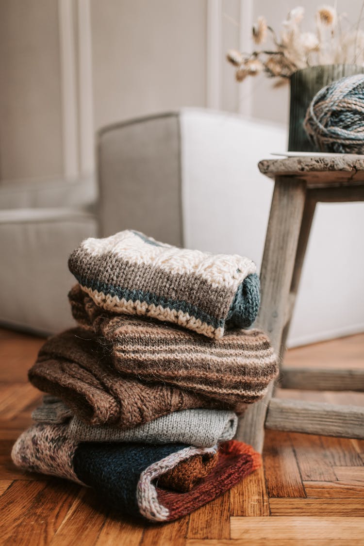 A Close-Up Shot Of A Stack Of Folded Scarves