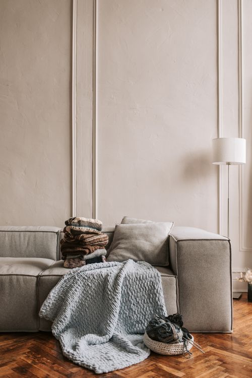 Free Elegant living room featuring a sofa with cozy textiles and wooden flooring. Stock Photo
