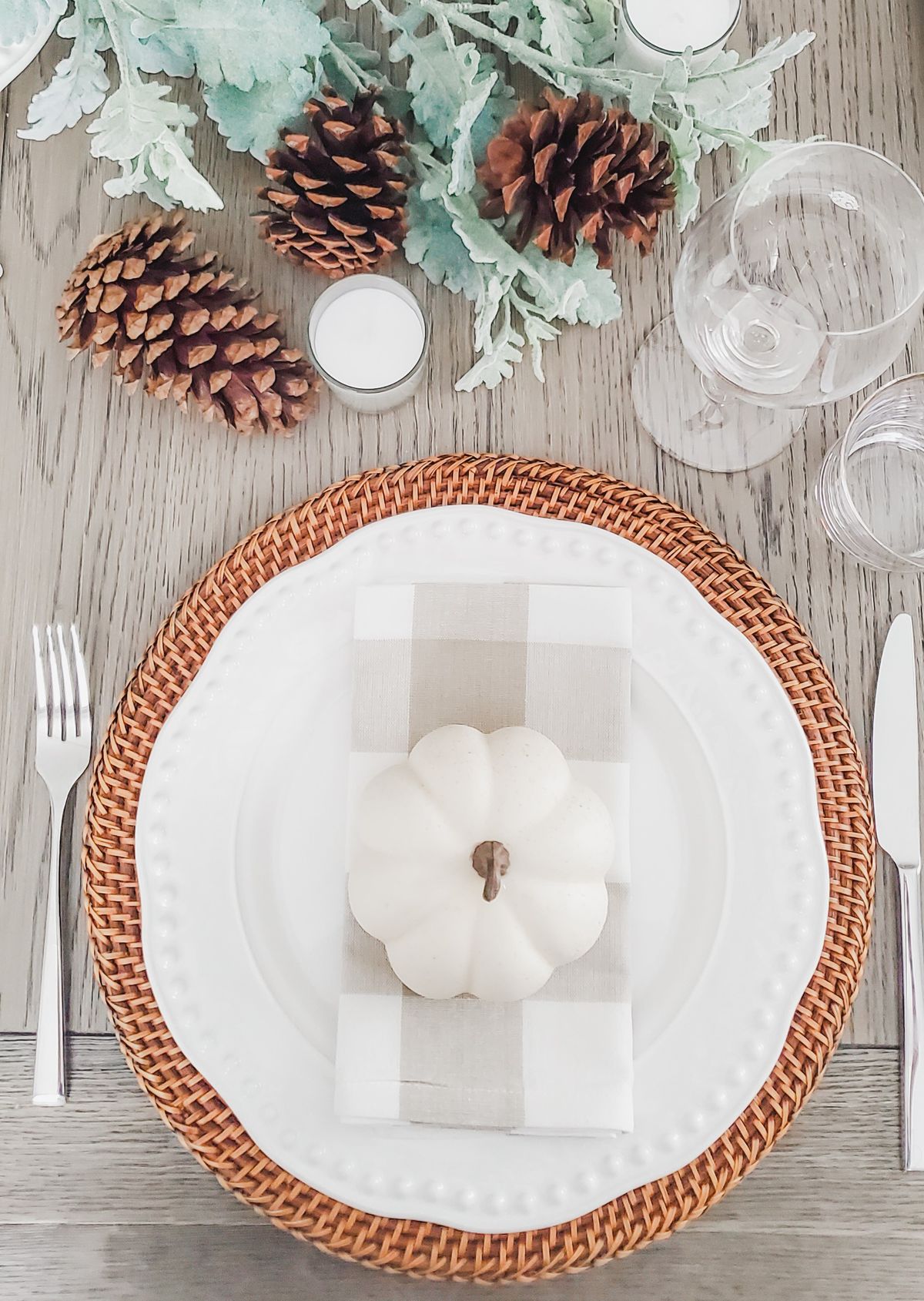 Cozy fall table decor with a white pumpkin and pinecones