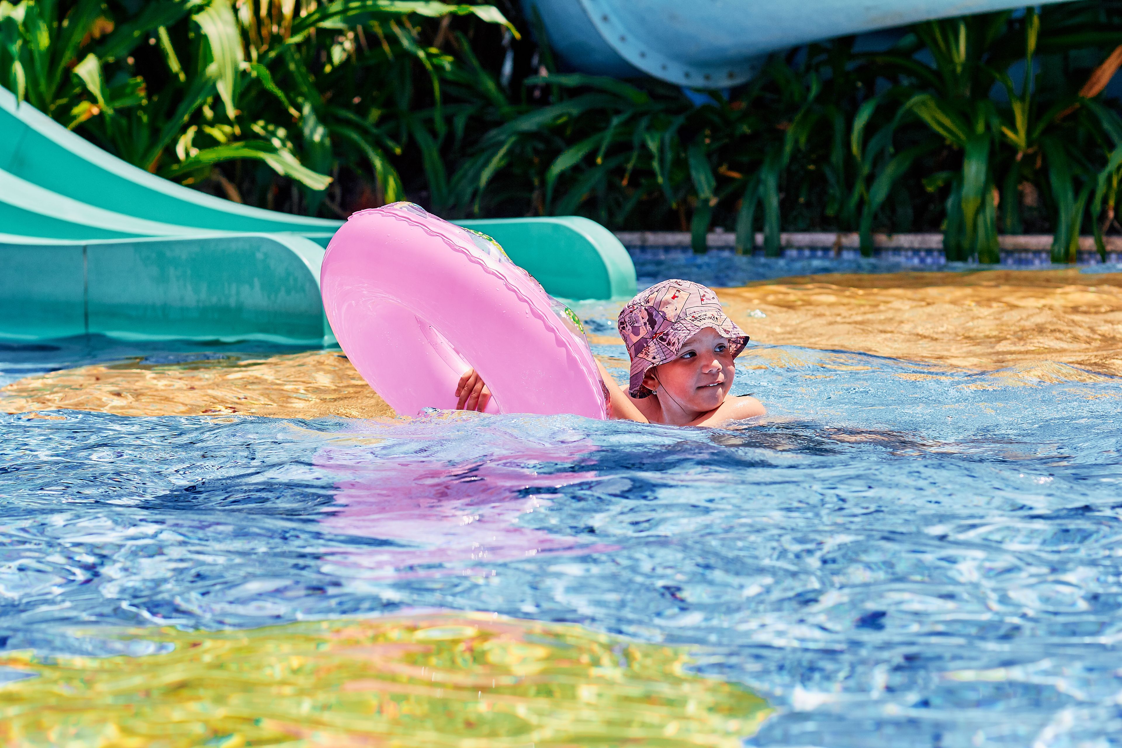 Children on water slides at the Splash water playground, Shangri-La Singapore