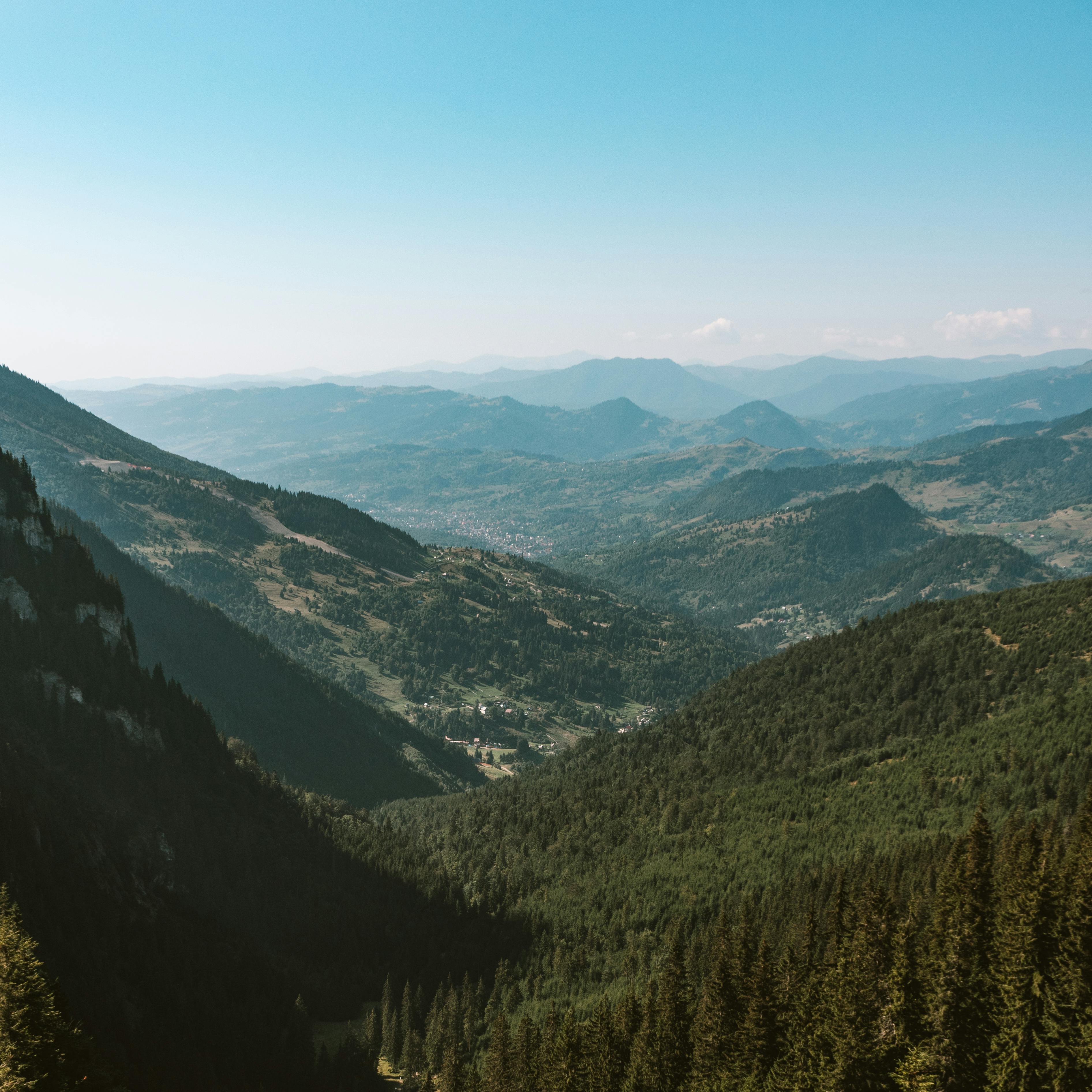 A breathtaking aerial view of the lush mountains and valleys in Borșa, Romania.
