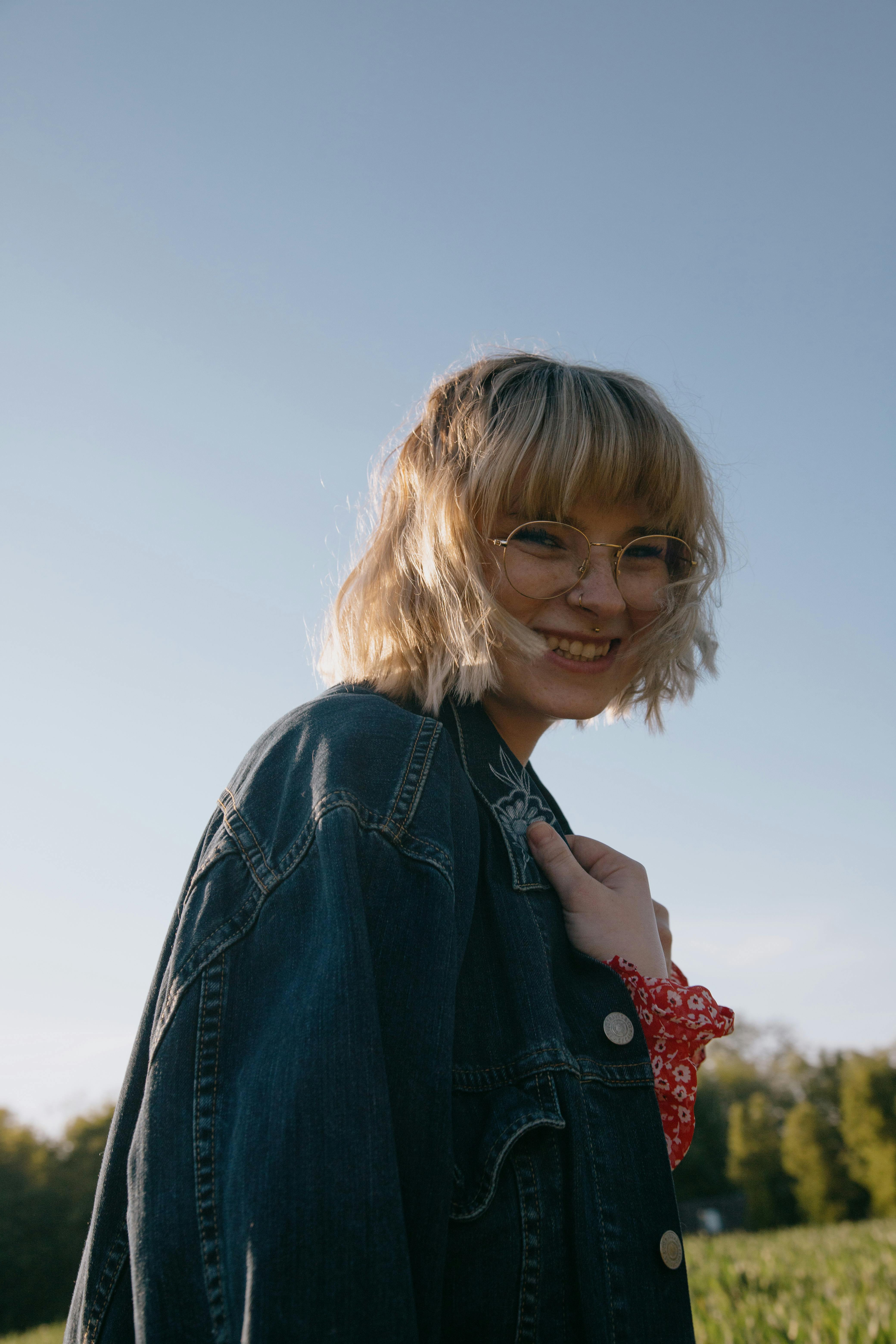 cheerful woman in meadow in daytime