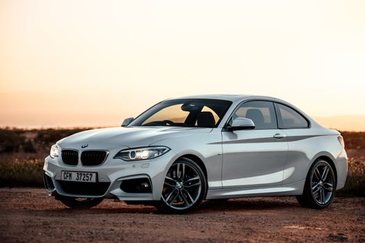 Stylish white BMW parked during sunset, capturing elegance and sophistication in Cape Town.
