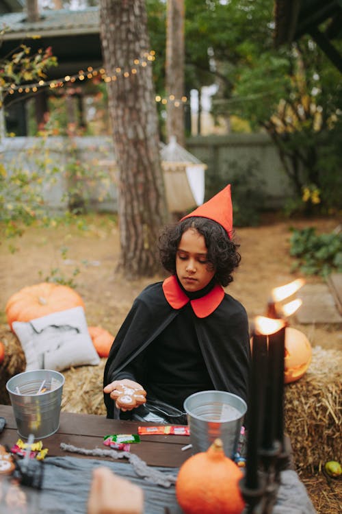 A Child Holding a Halloween Costume