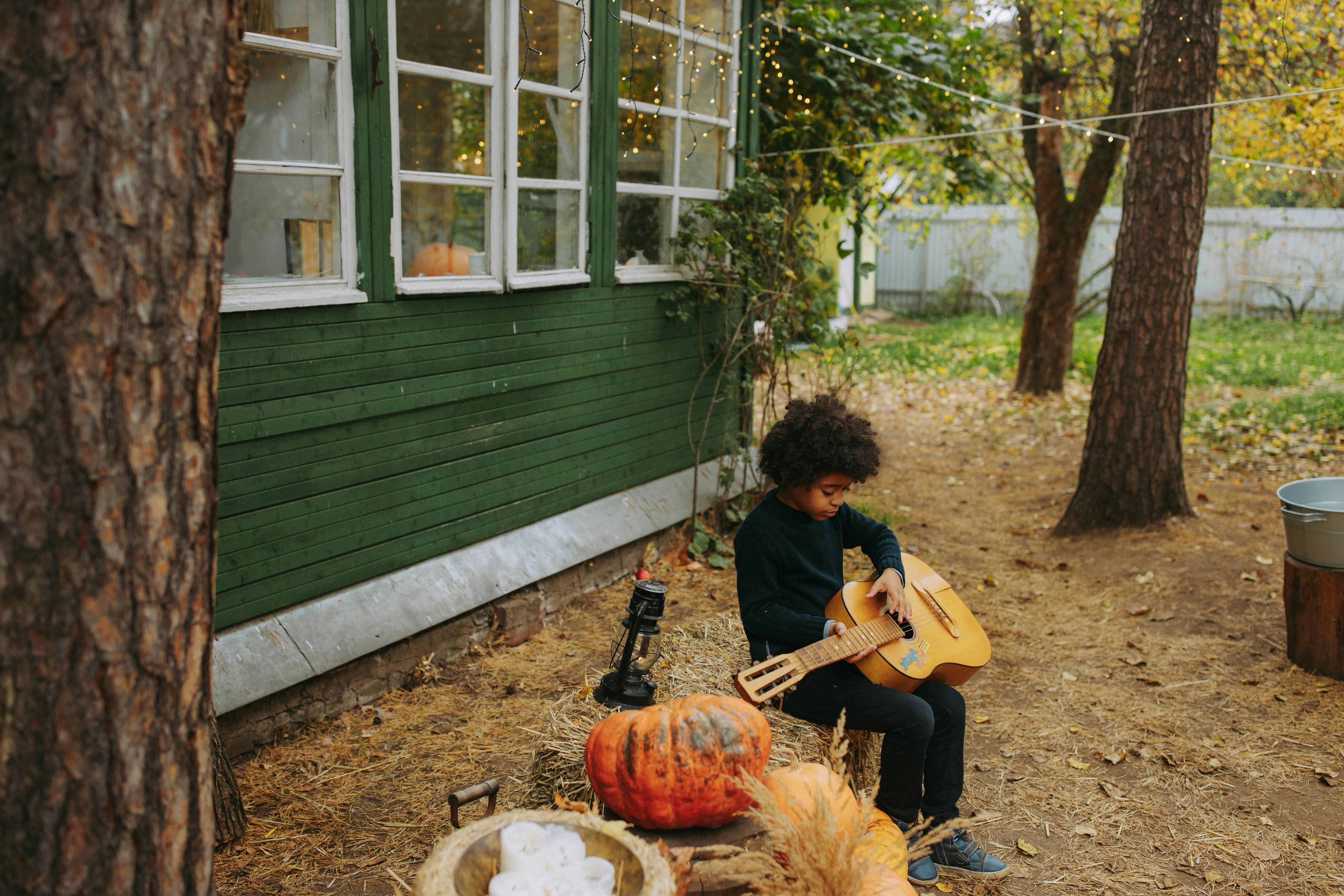 a young boy playing guitar