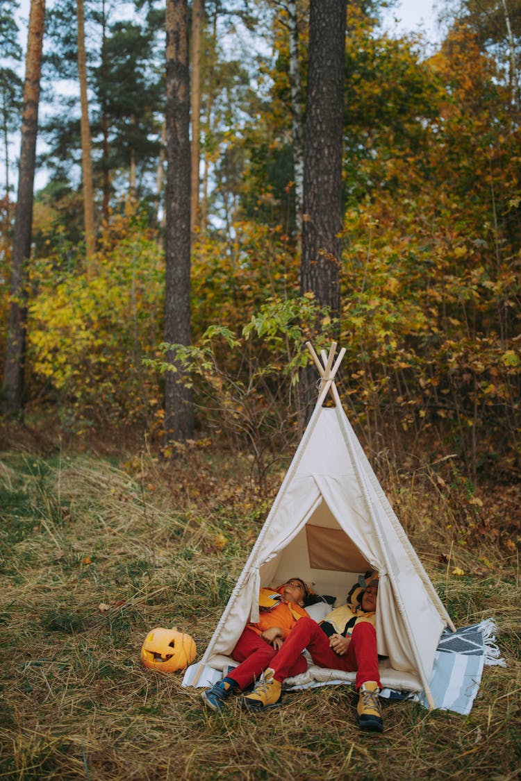 Children Lying Inside The Teepee On The Forest