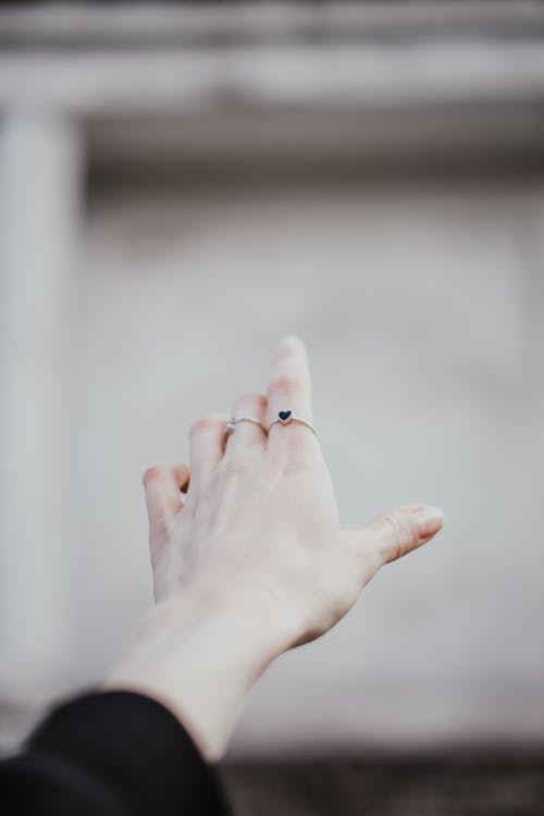 Free Person's Hand With Silver Ring Reaching Out Stock Photo